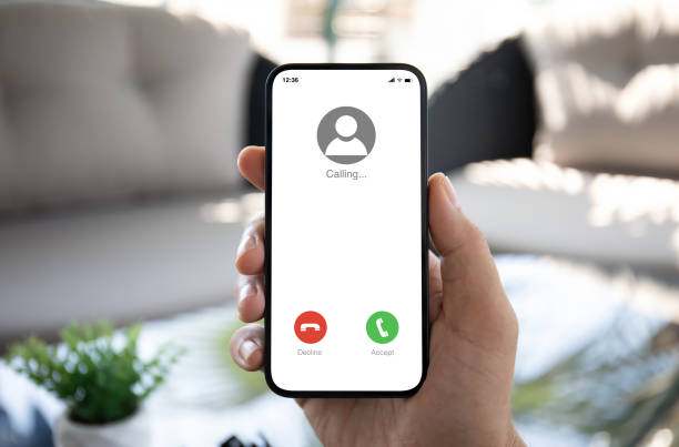 istock Man hand hold phone with incoming call on screen hotel 2153034976