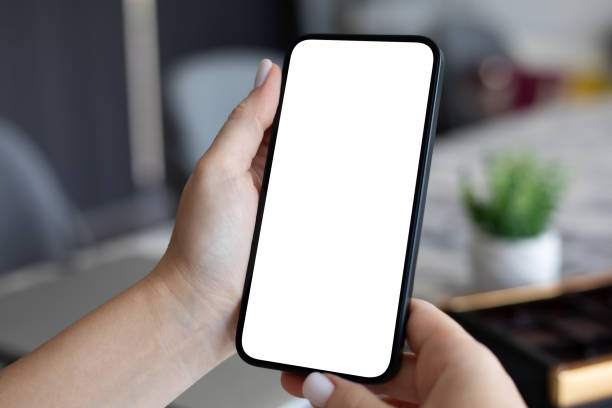 istock Female hand hold phone with isolated screen background cafe office 2153035247