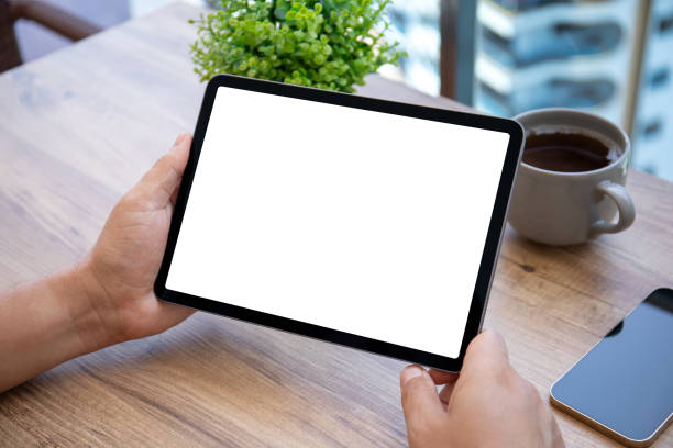 istock male hand hold computer tablet with isolated screen cafe office 2153036040
