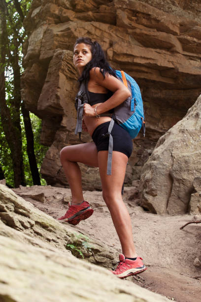 young woman rock climber climbing at  mountain rock