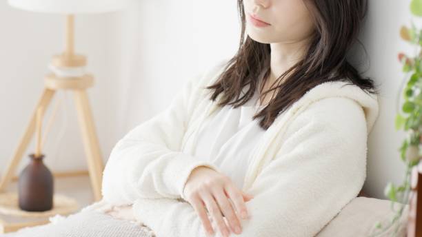 a woman worries in bed in the morning - 女性 ストックフォトと画像