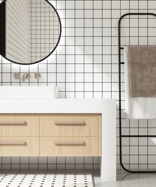 istock White bathroom vanity counter, washbasin, chrome faucet, mirror in sunlight on square tile wall, black grout line 2153038890
