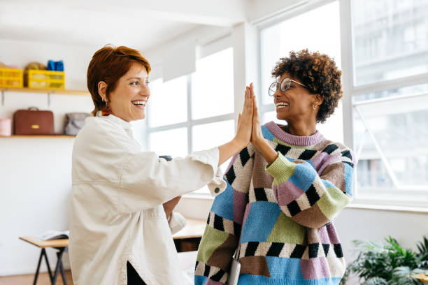 Colleagues celebrating success in a modern co-working space