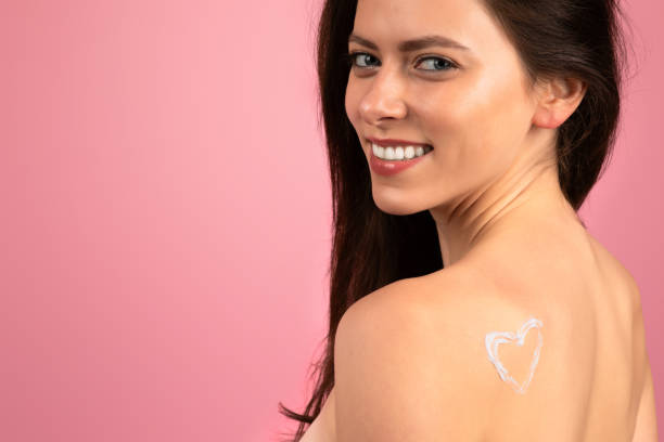 istock Radiant young woman with a heart-shaped lotion application on her shoulder 2153042035