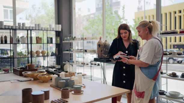 istock Customer making payment in pottery shop 2153042254