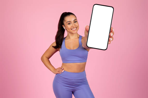 istock Smiling woman presenting smartphone screen 2153042760