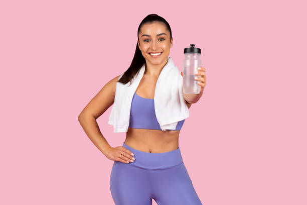 istock Active woman with water bottle and towel after workout 2153042835