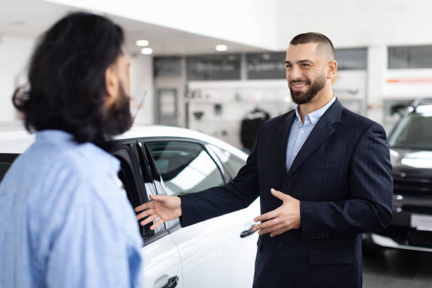 istock Professional car salesman talking to a client 2153047271