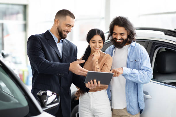 istock Salesperson showing tablet to customers 2153047284