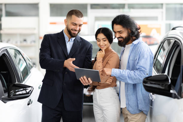 istock Indian couple checking papers or car specification on digital tablet 2153047305