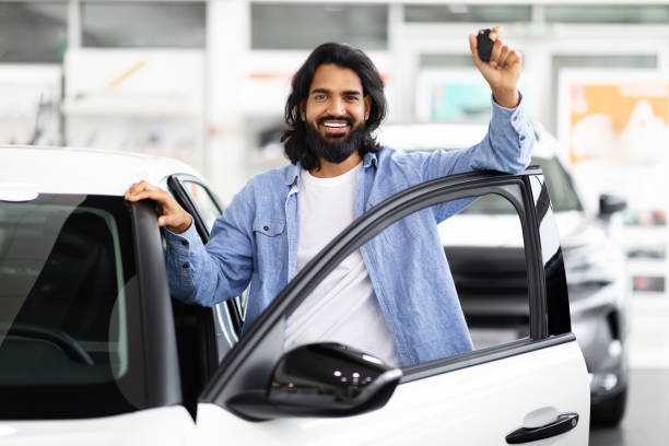 istock Happy indian man showing new car keys 2153047359