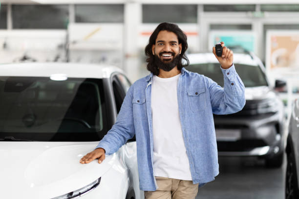 istock Man holding car keys at dealership 2153047367