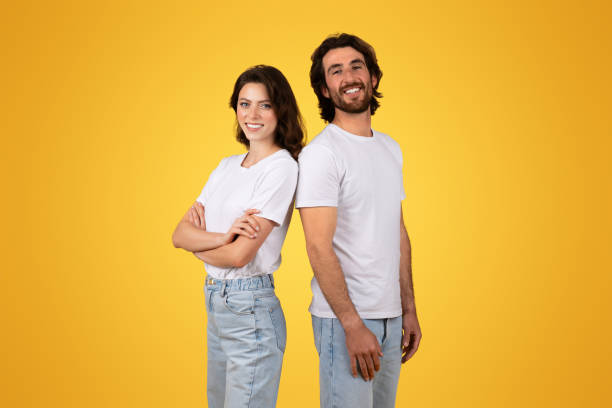 istock Side-by-side, a confident woman and a beaming man stand back-to-back 2153049320