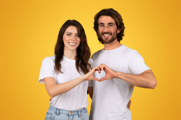 istock Affectionate couple creating a heart shape with their hands, smiling joyfully 2153049379
