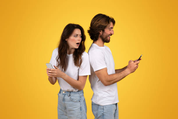 istock Shocked young woman holding a smartphone with a puzzled expression 2153049608