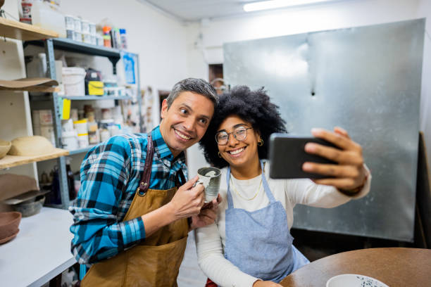 istock Coworkers taking selfie at ceramics workshop 2153049857