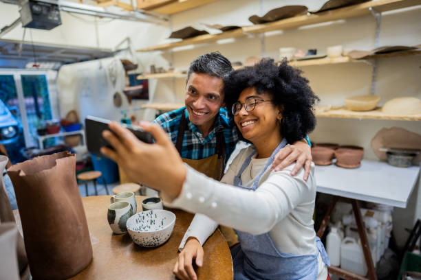 istock Coworkers taking selfie at ceramics workshop 2153049863