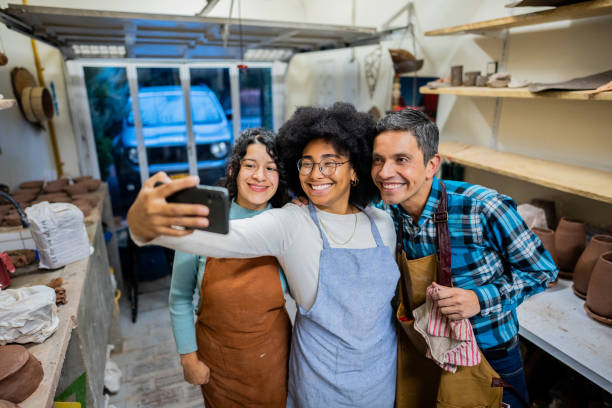 istock Coworkers taking selfie at ceramics workshop 2153049933
