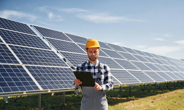 istock Engineer with photovoltaic solar panels outdoors at daytime 2153050340