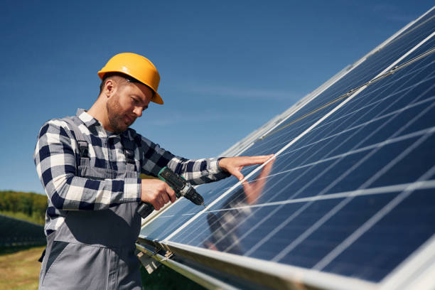 istock Almost done, installation by using drill. Engineer with photovoltaic solar panels outdoors at daytime 2153050556