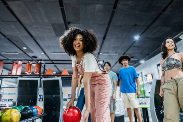 istock Young woman playing bowling on a bowling alley 2153050564