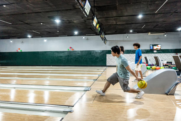 istock Young man playing bowling on a bowling alley 2153050824