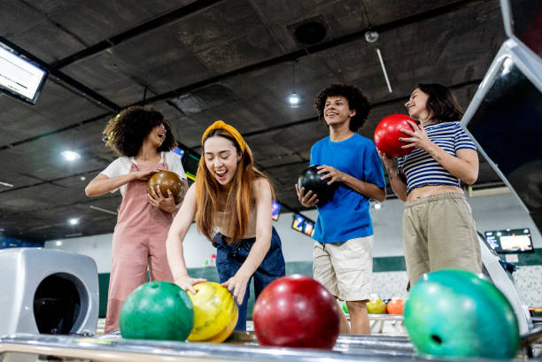 istock Friends playing bowling on a bowling alley 2153050887