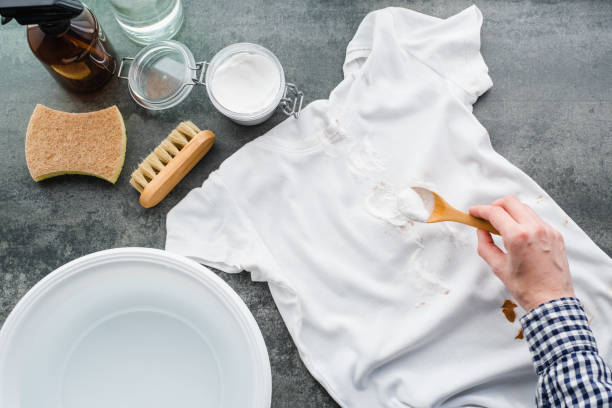 Splashing cosmetic cream or foundation on a white t-shirt.