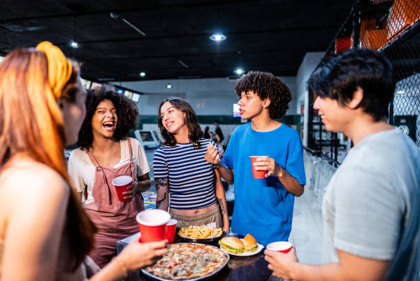 istock Friends eating and talking on a bowling alley 2153051167