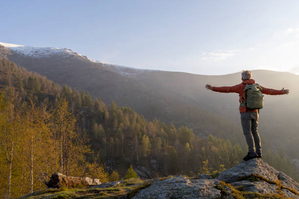 istock Mature hiker pauses on rock above misty hills 2153051199
