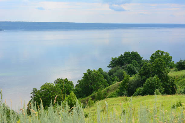 istock calm water with reflection with a few trees on the hill copy space 2153051503