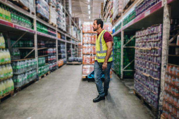 Mature man pulling a hand truck at the supermarket