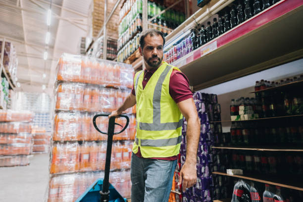 istock Mature man pulling a hand truck at the supermarket 2153051598