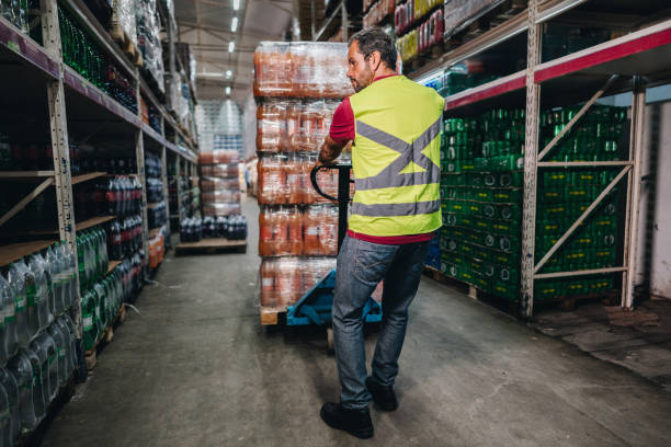 istock Mature man pulling a hand truck at the supermarket 2153051606