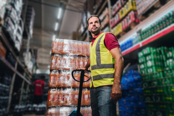 istock Mature man pulling a hand truck at the supermarket 2153051607