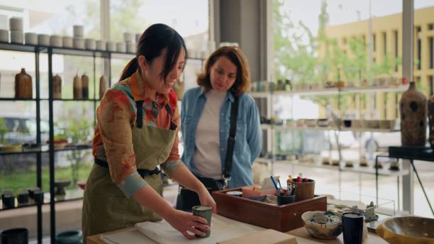 istock Asian female potter packaging pottery product for female customer 2153051659