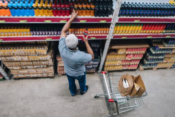 istock Senior man picking drinks at the supermarket 2153051724