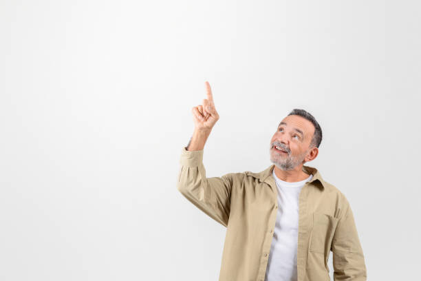 istock Place For Ad. Smiling senior man pointing up at copy space 2153052357