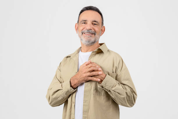 istock Gratitude Concept. Thankful Elderly Man Keeping Both Palms On Chest 2153052375