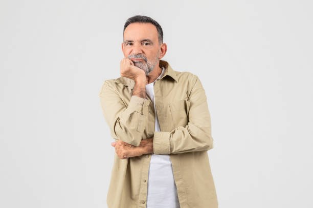 istock Thoughtful senior man with chin on hand looking away 2153052454