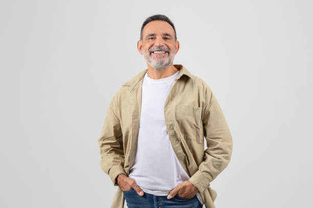 istock Smiling senior man standing with hands in pockets 2153052459