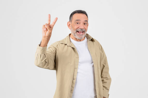 istock Cheerful senior man showing peace sign with a smile 2153052480