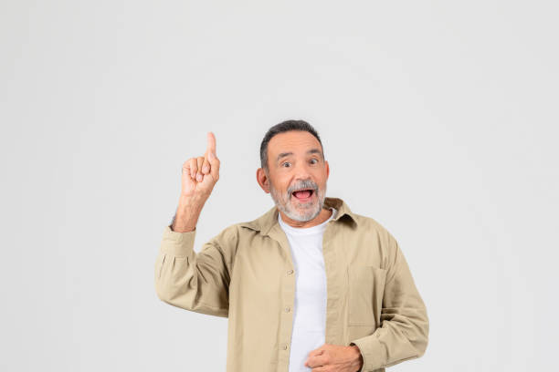 istock Excited senior pointing upwards on white background 2153052504