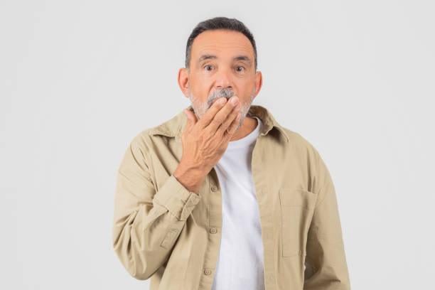 istock Mature man looking surprised and covering mouth 2153052514