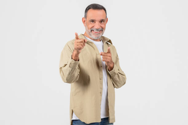 istock Happy senior pointing both fingers at camera 2153052516