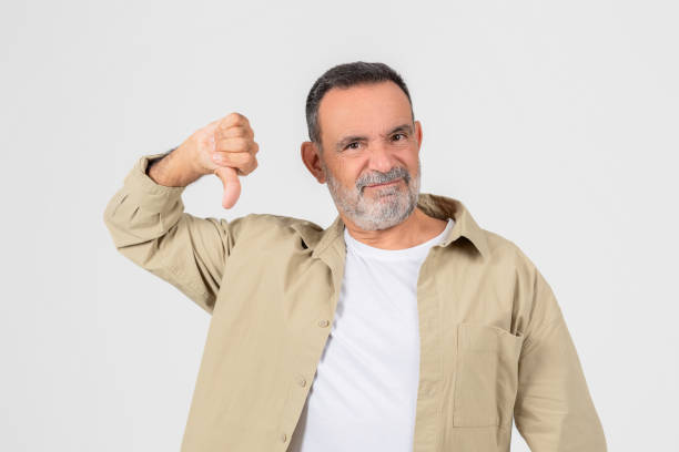 istock Senior man showing thumbs down in disapproval 2153052537