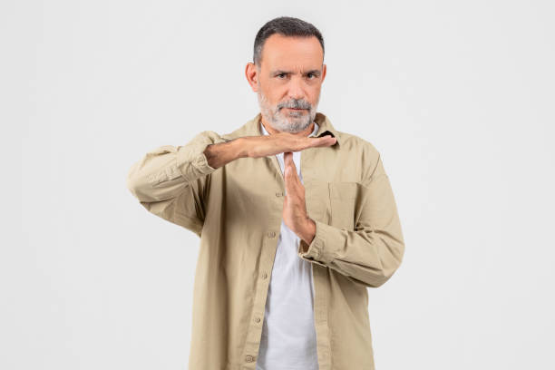 istock Mature man gesturing time out sign on background 2153052549