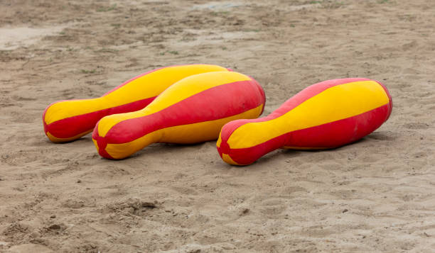 istock Toy bowling pins on the sand 2153052641