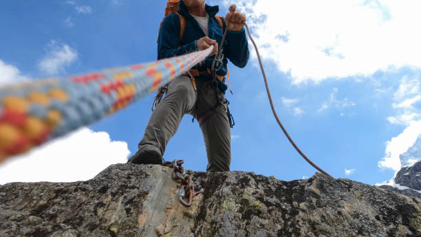 POV up climber's rope to guide on top of mountain