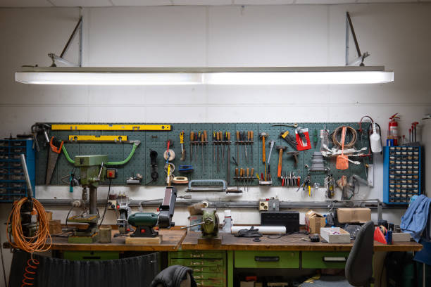 istock Old factory work shop table and wall mounted tool rack, no people 2153057404